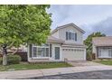 Charming two-story home with a well-manicured lawn, brick driveway, and a front-facing two car garage at 20000 E Mitchell Pl # 35, Denver, CO 80249