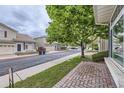 Street view of a neighborhood featuring well-maintained homes with manicured lawns and mature trees at 20000 E Mitchell Pl # 35, Denver, CO 80249
