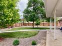 Spacious backyard with a well-kept lawn and mature trees, perfect for outdoor activities at 209 S 13Th Ave, Brighton, CO 80601