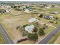 Aerial view of sprawling land with a home, barn, and various outbuildings in a rural setting at 4627 Cathy Ln, Erie, CO 80516