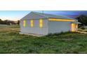 Exterior shot of large metal barn with light filtering through windows during daytime at 4627 Cathy Ln, Erie, CO 80516