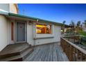 Charming home entrance featuring a lovely wooden deck and a secure front door at 4627 Cathy Ln, Erie, CO 80516