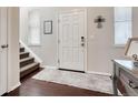 Bright foyer with hardwood floors and a staircase, creating an inviting entrance at 3793 Cadence Dr, Castle Rock, CO 80109