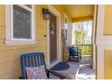 Charming front porch with comfortable seating, a welcoming 'hello' wreath, and natural light at 3793 Cadence Dr, Castle Rock, CO 80109