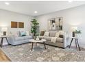 Comfortable living room featuring stylish sofas and a decorative rug at 5553 S Datura St, Littleton, CO 80120
