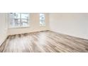 Bright bedroom featuring large windows and stylish wood-look flooring at 918 Promenade Dr, Superior, CO 80027