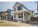 Charming two-story home with a covered front porch, white siding, and modern design at 918 Promenade Dr, Superior, CO 80027