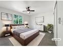 Modern bedroom with a large window, ceiling fan, contemporary furniture and a cozy rug at 542 Hawthorn Cir, Frederick, CO 80530