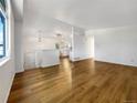 Bright and airy living room with beautiful hardwood floors and fresh white walls at 542 Hawthorn Cir, Frederick, CO 80530