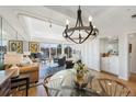 Open-concept living and dining area with modern decor, a chandelier, and panoramic views at 1900 E Girard Pl # 500, Englewood, CO 80113