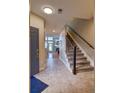 Spacious entryway with tile flooring, staircase, and natural light, creating a grand entrance to the home at 11257 W Radcliffe Dr, Littleton, CO 80127