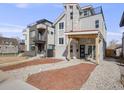 Modern home featuring a stone tower, a porch with a swing, a balcony, and contemporary architectural design at 3948 Wyandot St, Denver, CO 80211