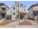 This contemporary two-story home features stone accents, a balcony, a welcoming porch with a swing, and great curb appeal at 3948 Wyandot St, Denver, CO 80211