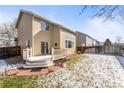 Backyard with a wooden deck, grassy area, and a full fence at 18734 E Linvale Pl, Aurora, CO 80013