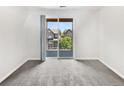 Bedroom featuring natural light, gray carpet, and sliding door to the outside at 4100 Albion St # 523, Denver, CO 80216