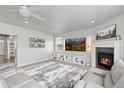 Open living room showcasing a fireplace, built-in shelving, and a comfortable gray sectional at 1315 Sidewinder Cir, Castle Rock, CO 80108