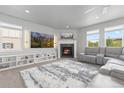 Bright living room featuring a fireplace, built-in shelving, and a plush gray sectional at 1315 Sidewinder Cir, Castle Rock, CO 80108