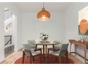 Elegant dining room with a round table, stylish chairs, and modern lighting, perfect for gatherings at 3322 W 26Th Ave, Denver, CO 80211