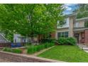 Attractive home with a well-manicured lawn, lush landscaping, and a large tree providing shade and beauty at 3322 W 26Th Ave, Denver, CO 80211