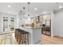 Modern kitchen with granite countertops, stainless steel appliances, and an eat-in island with barstool seating at 3322 W 26Th Ave, Denver, CO 80211
