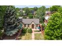 Lovely aerial view of charming brick home with manicured lawn and blue sky at 2435 N Irving St, Denver, CO 80211