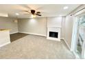Inviting living room with plush carpet, fireplace, and sliding glass door at 64 Nome Way # C, Aurora, CO 80012