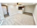 Bright and airy living room showcasing open-concept design with kitchen access at 64 Nome Way # C, Aurora, CO 80012