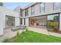 Inviting patio with modern furniture, a sleek kitchen viewable through large glass doors at 1626 S Sherman St, Denver, CO 80210