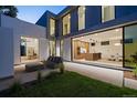 Inviting patio with modern furniture, a sleek kitchen viewable through large glass doors at 1626 S Sherman St, Denver, CO 80210