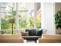 Close up of bright living room featuring a wall of windows and comfortable seating arrangement at 1401 Delgany St # 202, Denver, CO 80202