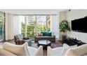 Bright living room featuring a wall of windows, a TV, and comfortable seating arrangement at 1401 Delgany St # 202, Denver, CO 80202