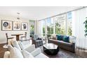 Bright living room with large windows, hardwood floors, and comfortable seating at 1401 Delgany St # 202, Denver, CO 80202