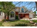 Beautiful home with a manicured lawn, mature trees, brick accents, and a spacious driveway at 105 Hawthorn St, Frederick, CO 80530