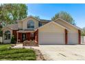 Two-story home with a well-manicured lawn and a spacious three-car garage at 105 Hawthorn St, Frederick, CO 80530