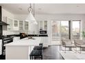 Bright kitchen featuring a large island, stainless steel appliances, and modern pendant lighting at 1438 Little Raven St # 104, Denver, CO 80202
