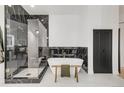 Luxurious bathroom featuring a freestanding tub, glass enclosed shower with marble accents, and modern fixtures at 520 Columbine St, Denver, CO 80206