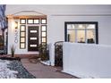 Modern front entrance with a dark door and a brick walkway at 520 Columbine St, Denver, CO 80206