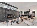 Open-concept living room showcasing a modern fireplace, sleek black accents, and an adjacent kitchen at 520 Columbine St, Denver, CO 80206