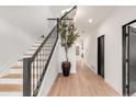 Elegant staircase with a metal railing and light wood steps at 520 Columbine St, Denver, CO 80206