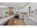 Modern kitchen boasts white cabinets, stainless steel appliances, and a quartz countertop with a stylish backsplash at 41 Eagle Dr, Littleton, CO 80123