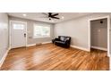 Bright living room with hardwood floors, a ceiling fan, and a large window for natural light at 1945 Yosemite St, Denver, CO 80220