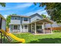A spacious backyard features a covered patio, lush lawn, and play area at 7900 E Iowa Ave, Denver, CO 80231