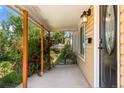 View of the home's front porch featuring new paint, and well-manicured landscaping at 46 S Perry St, Denver, CO 80219