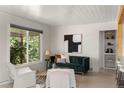 Bright living room with updated finishes, a large window, and stylish furnishings at 46 S Perry St, Denver, CO 80219