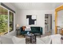 Bright living room with updated finishes, a large window, and stylish furnishings at 46 S Perry St, Denver, CO 80219