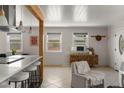 Open-concept living area with cozy seating, a stylish cabinet, and bright natural light at 46 S Perry St, Denver, CO 80219