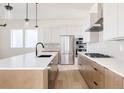 Modern kitchen featuring white cabinetry, stainless steel appliances, and a quartz countertop island at 11324 Alla Breve Cir, Lone Tree, CO 80134