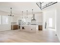 Spacious open-concept kitchen with stainless steel appliances, a large island, and an open staircase at 11324 Alla Breve Cir, Lone Tree, CO 80134