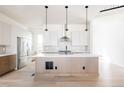 Bright, modern kitchen with stainless steel appliances, quartz countertops, a sleek island, and pendant lighting at 11324 Alla Breve Cir, Lone Tree, CO 80134