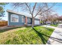 Street view of a charming blue single Gathering home with a two car garage and mature trees at 1444 S Richfield Way, Aurora, CO 80017